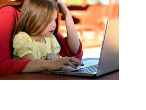 child held by woman at computer